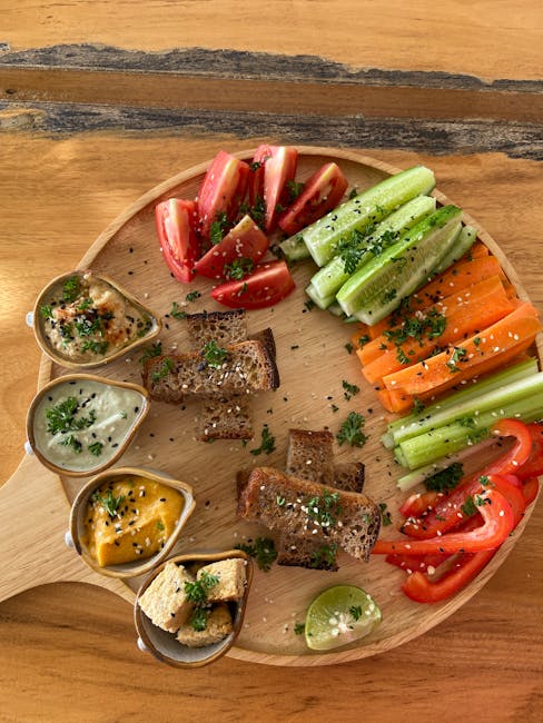 Fresh orange carrots with vibrant green tops arranged on a rustic wooden cutting board